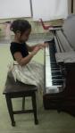 Janai getting comfortable with the piano at Suburban Music School